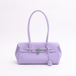 Load image into Gallery viewer, A lavender purple leather handbag with a top handle, front strap detail, and silver-tone hardware, photographed against a clean white background.
