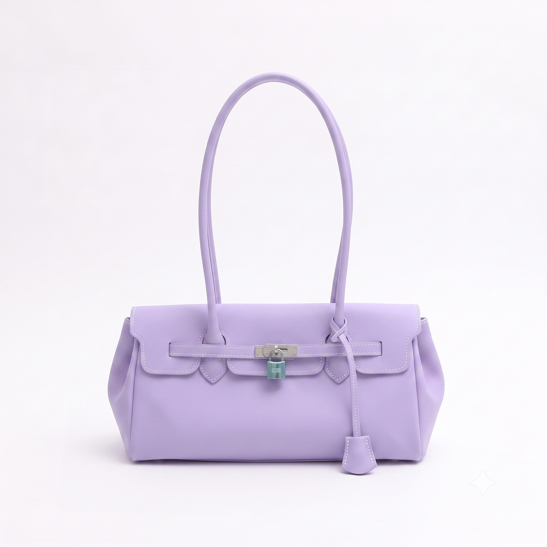A lavender purple leather handbag with a top handle, front strap detail, and silver-tone hardware, photographed against a clean white background.